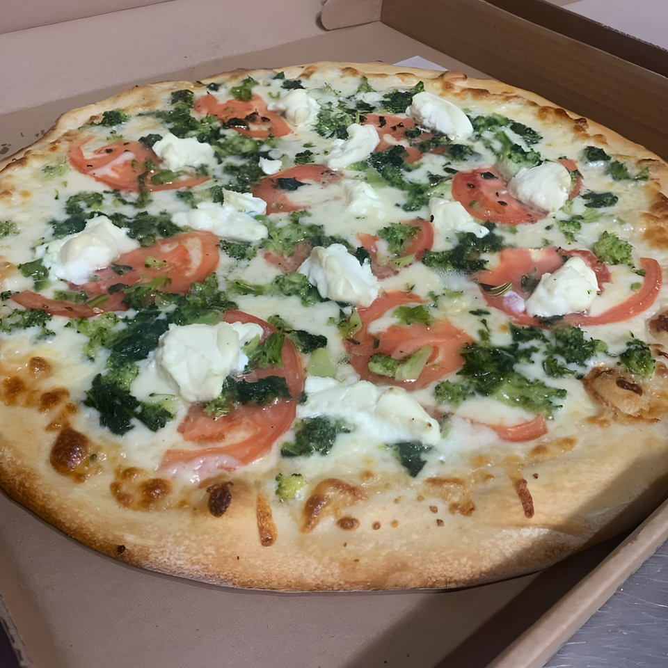 Gino's Pizza and Grill's white pizza with broccoli, tomatoes, and ricotta cheese in a box.