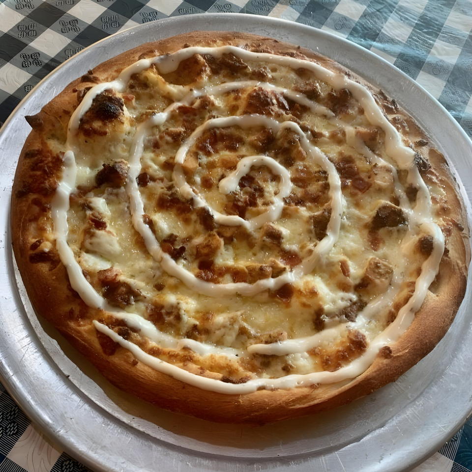 Gino's Pizza and Grill's chicken bacon ranch pizza with a spiral of ranch dressing.